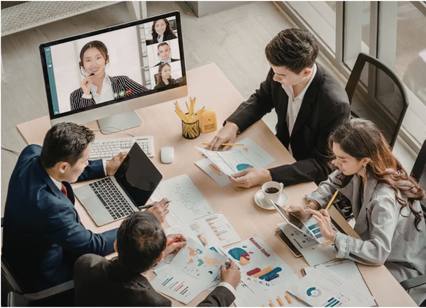 A client team meeting with their remote assistant over video